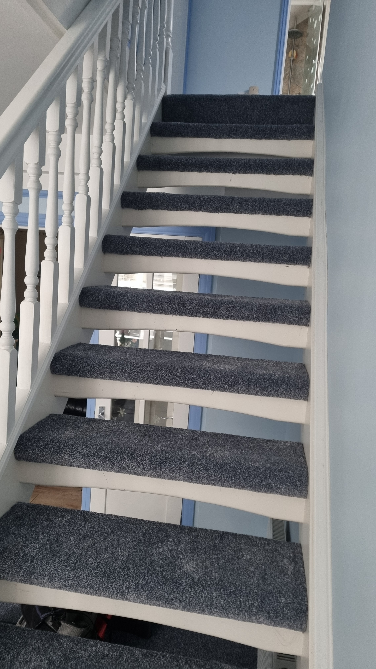 Stair carpet fitter on stairs in a home in Swanage.