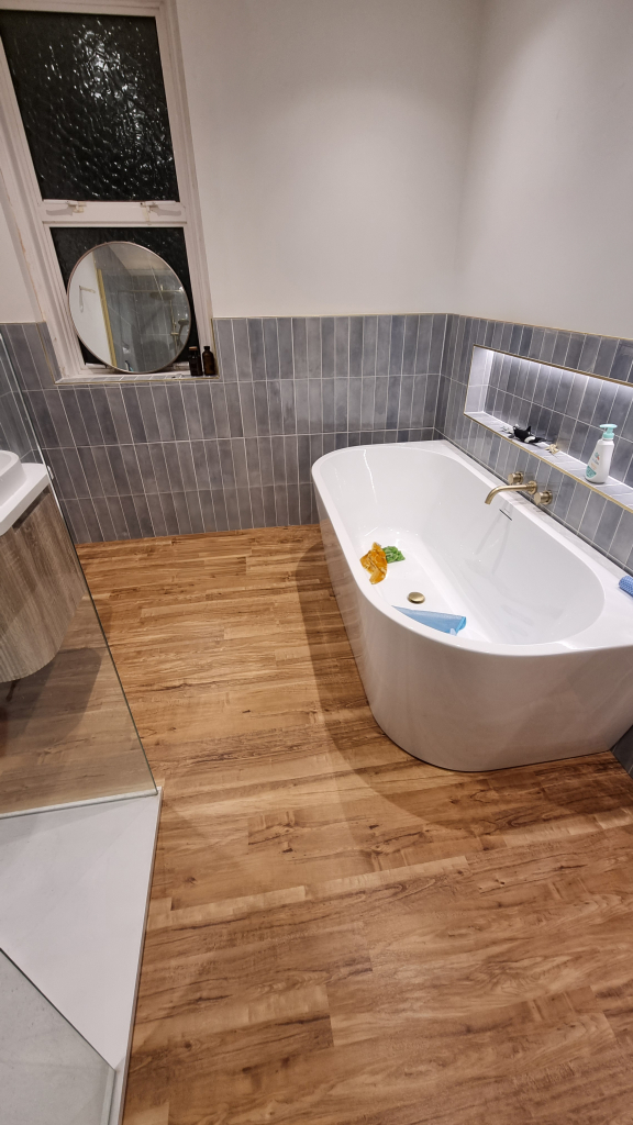 A wood effect let tile installed on bathroom floor in Swanage home.