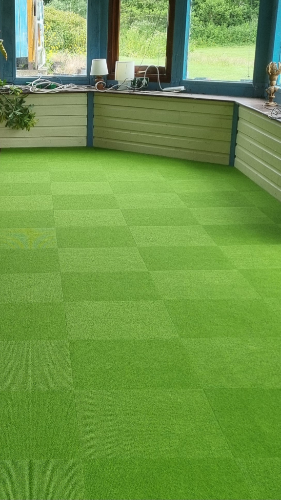 Green commercial carpet tiles fitted at Swanage Golf Games.