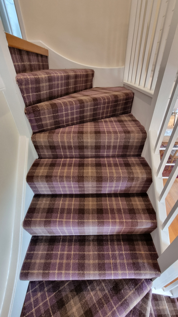 A tartan carpet installation on stairs in Swanage A tartan carpet installation on stairs in Swanage